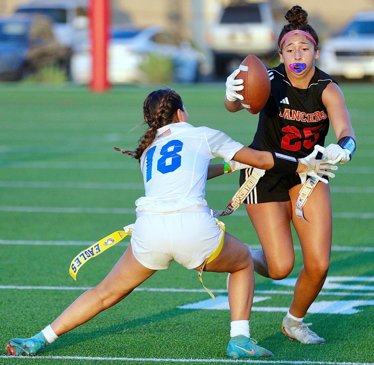 Orange Lutheran's Brookelynn Vanderkallen tries to rush past Santa Margarita's Mackenzie Young during a Trinity League game.