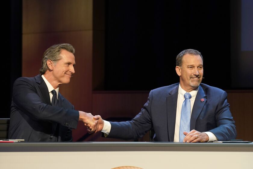 Gubernatorial candidates Democratic Gov. Gavin Newsom, left, and Republican challenger state Sen. Brian Dahle shake hands after their debate held by KQED Public Television in San Francisco, Sunday, Oct. 23, 2022. (AP Photo/Rich Pedroncelli, Pool)