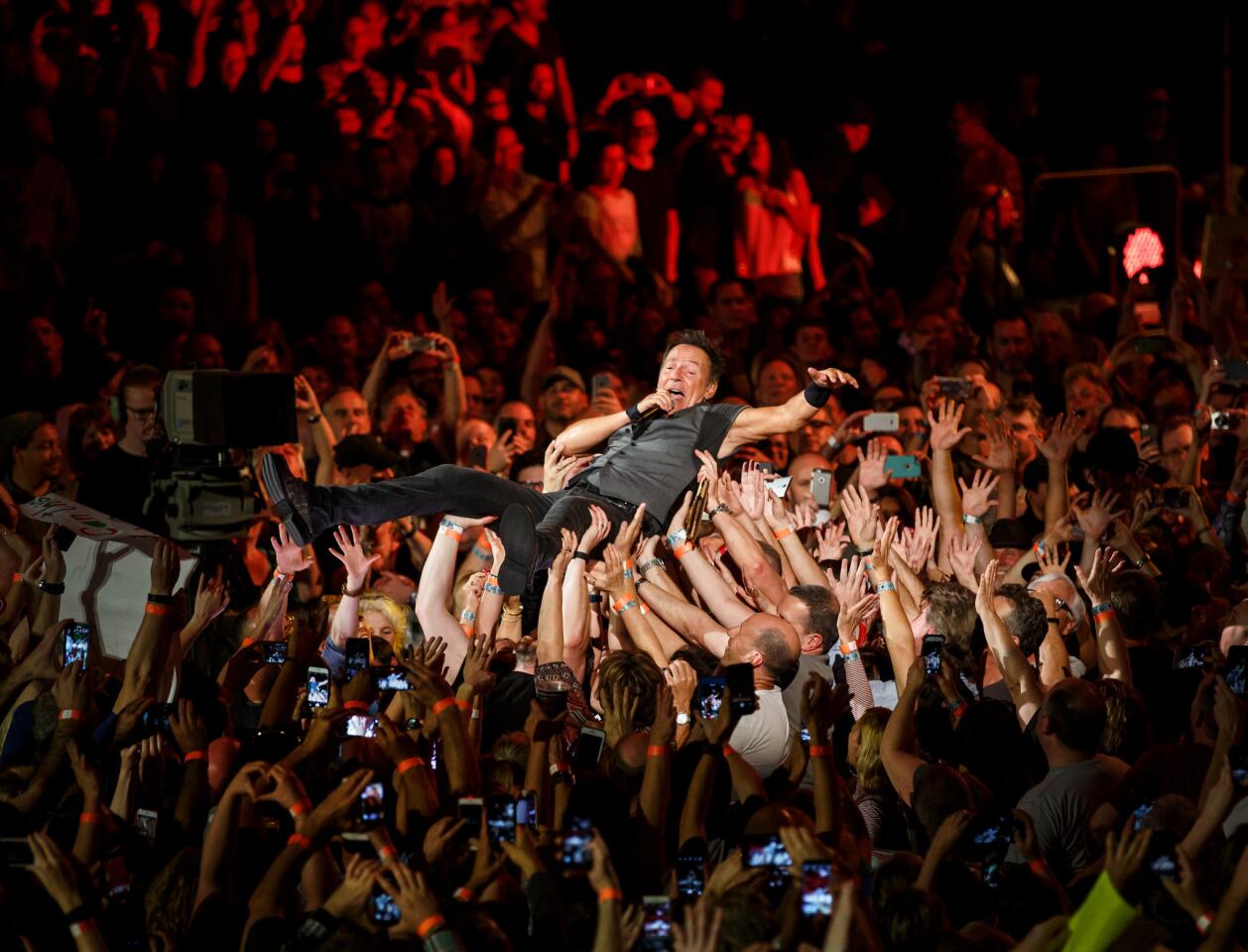Bruce Springsteen goes crowd-surfing at the L.A. Sports Arena. Read the review.