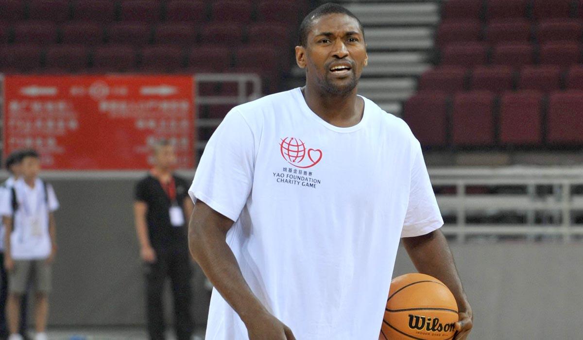 Metta World Peace coaches some youth players during a camp in Beijing last year.