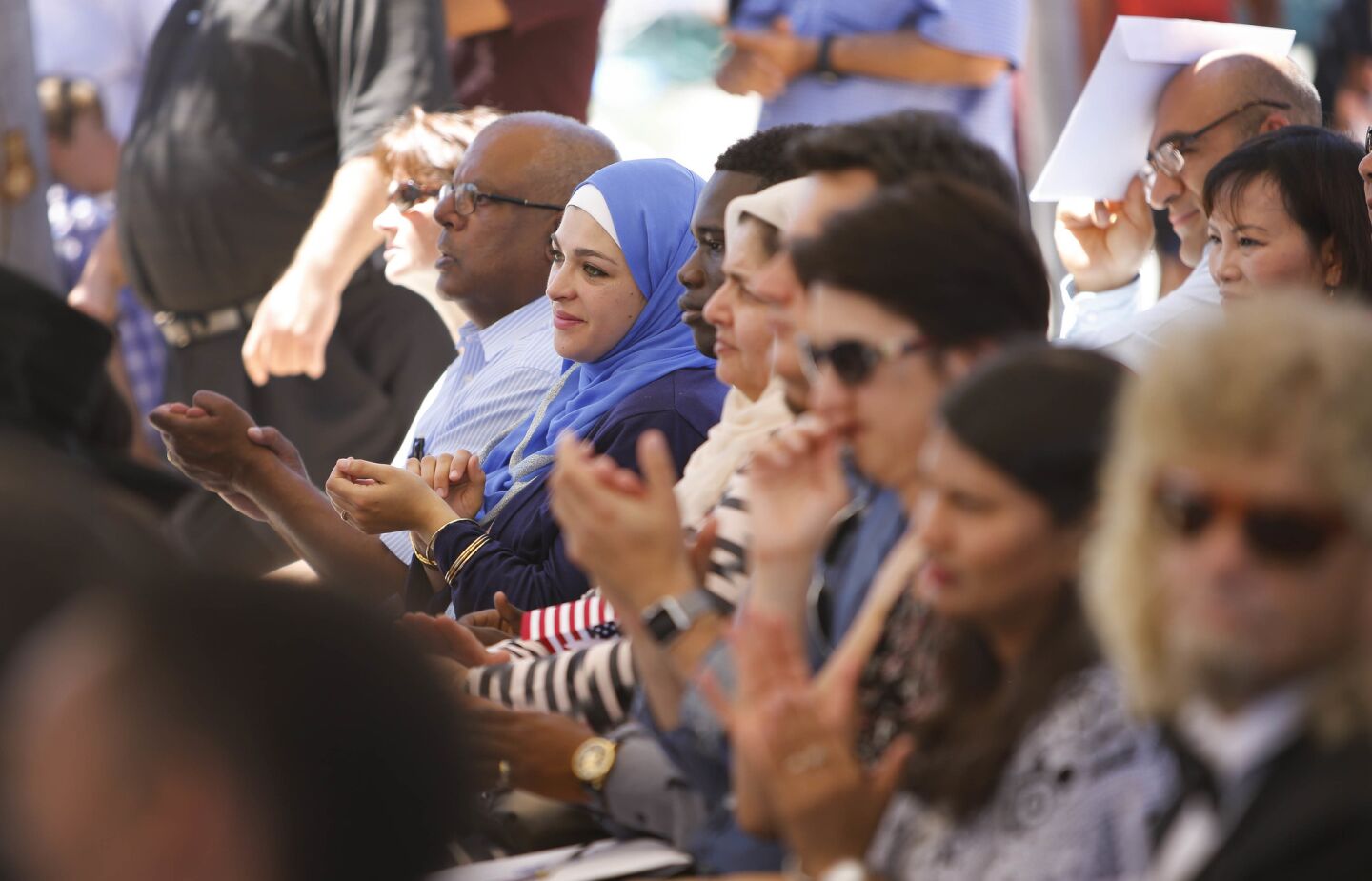 Duaa Saeed, second from left, originally from Jordan, was one of about 100 people from about 54 countries who took the Oath of Allegiance to the United States of America and became U.S. citizens in a naturalization ceremony held in Centennial Plaza near El Cajon City Hall to kickoff El Cajon's, America on Main Street festivities.