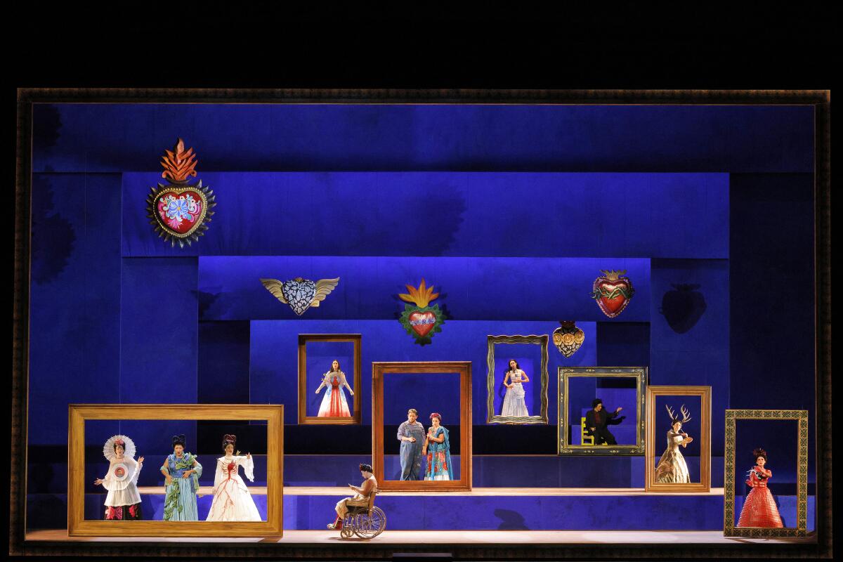A stark blue set that features a sequence of rectangular geometric forms, features opera singers in Mexican costume