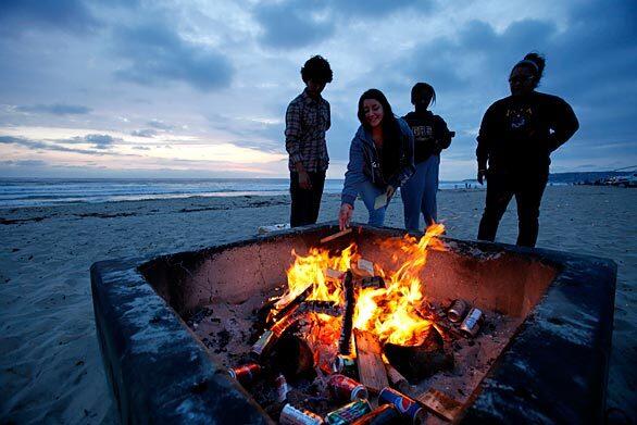 San Diego residents Eliseo Rivas, 18, left, Alyx Balter, 18, Sewit Berhane, 18, and Alexis Najera, 17, celebrate Berhane's birthday at Mission Beach.