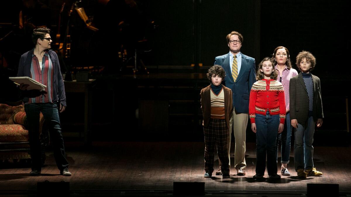 Kate Shindle as Alison Bechdel looks toward an earlier version of her family, played by, from left, Lennon Nate Hammond, Robert Petkoff, Alessandra Baldacchino, Susan Moniz and Pierson Salvador in the touring production of "Fun Home."