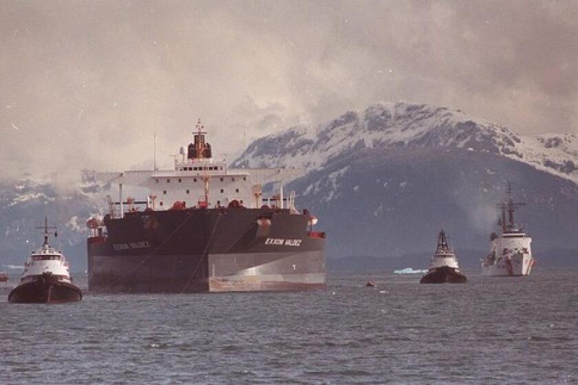The Exxon Valdez is towed out of Prince William Sound in Alaska in June 1989, three months after it hit a reef and spilled 11 million gallons of crude oil.