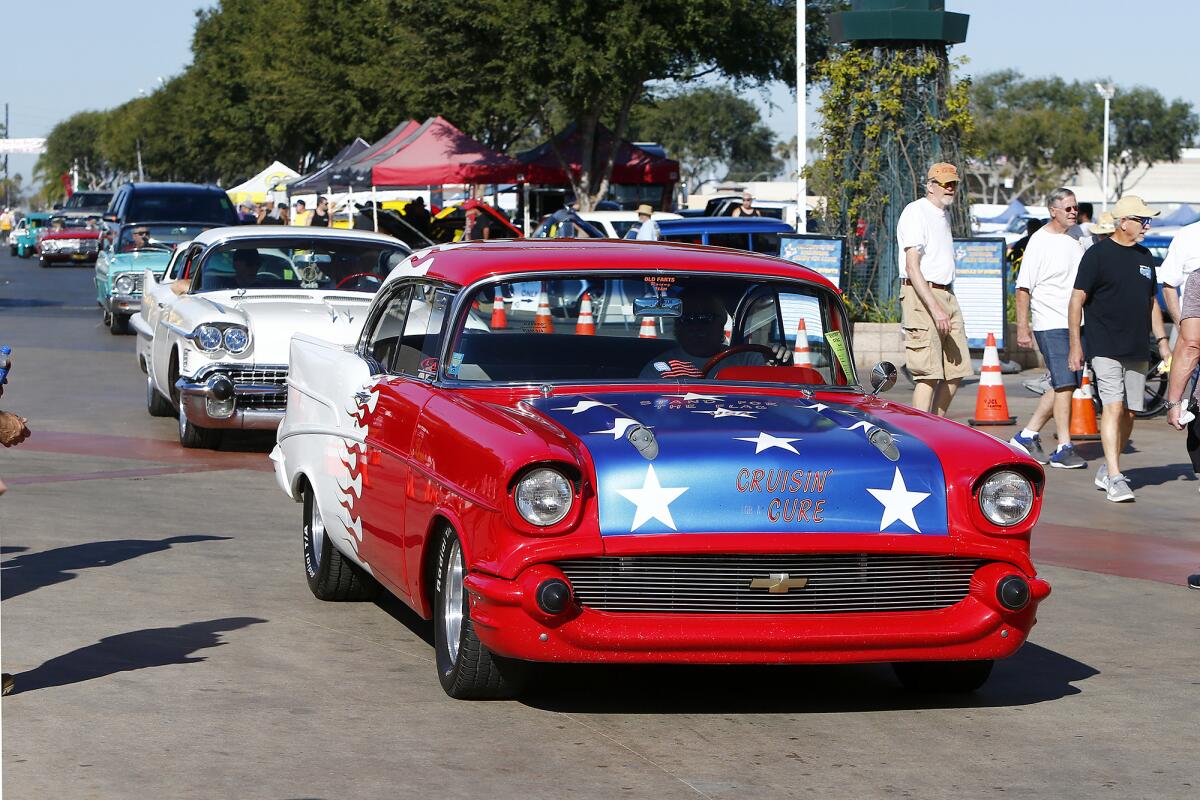 Car lovers drive through the Orange County fairgrounds Saturday during Cruisin' for a Cure in Costa Mesa. 