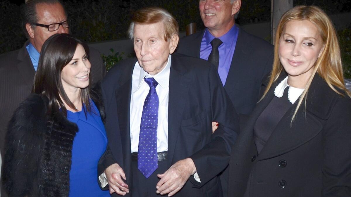 Sumner Redstone with former girlfriend Sydney Holland, left, and companion Manuela Herzer at a 2013 charity event.