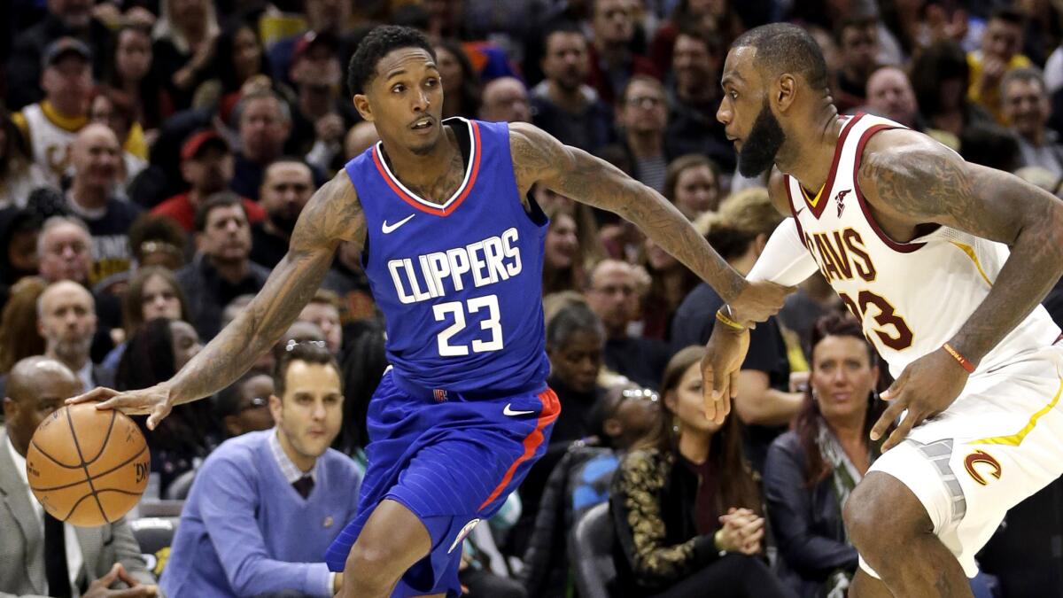 Clippers guard Lou Williams tries to drive around Cavaliers forward LeBron James during the second half Friday.