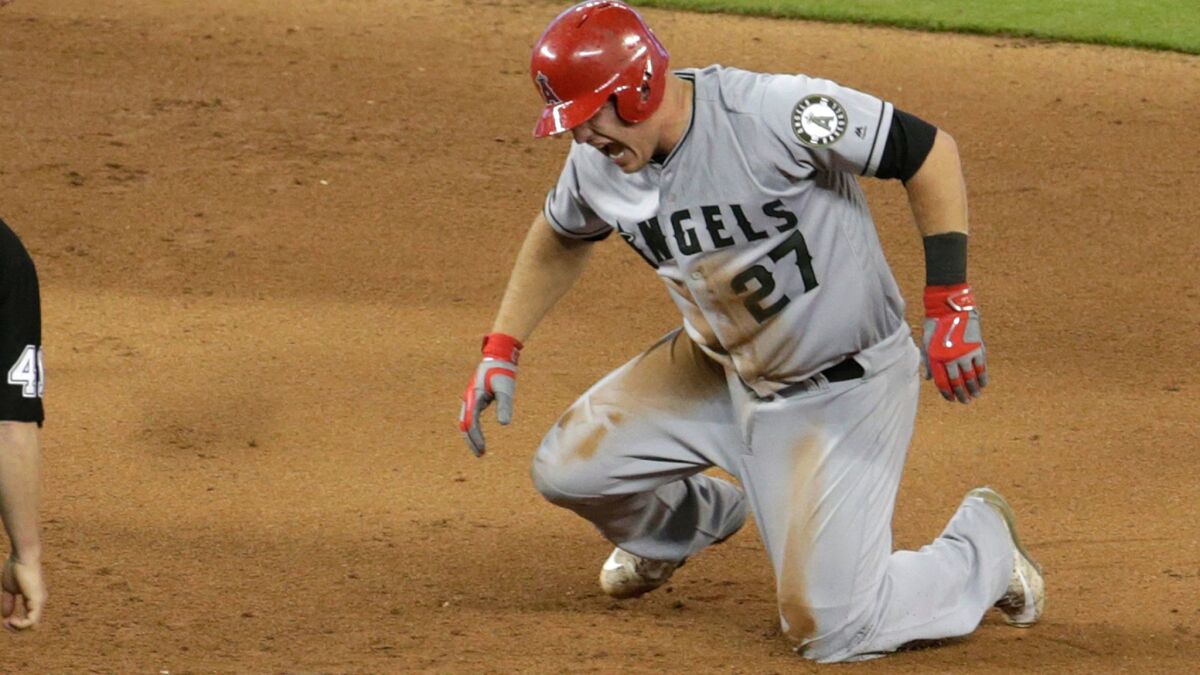 Mike Trout cries out in pain after tearing a thumb ligament while sliding into second base.