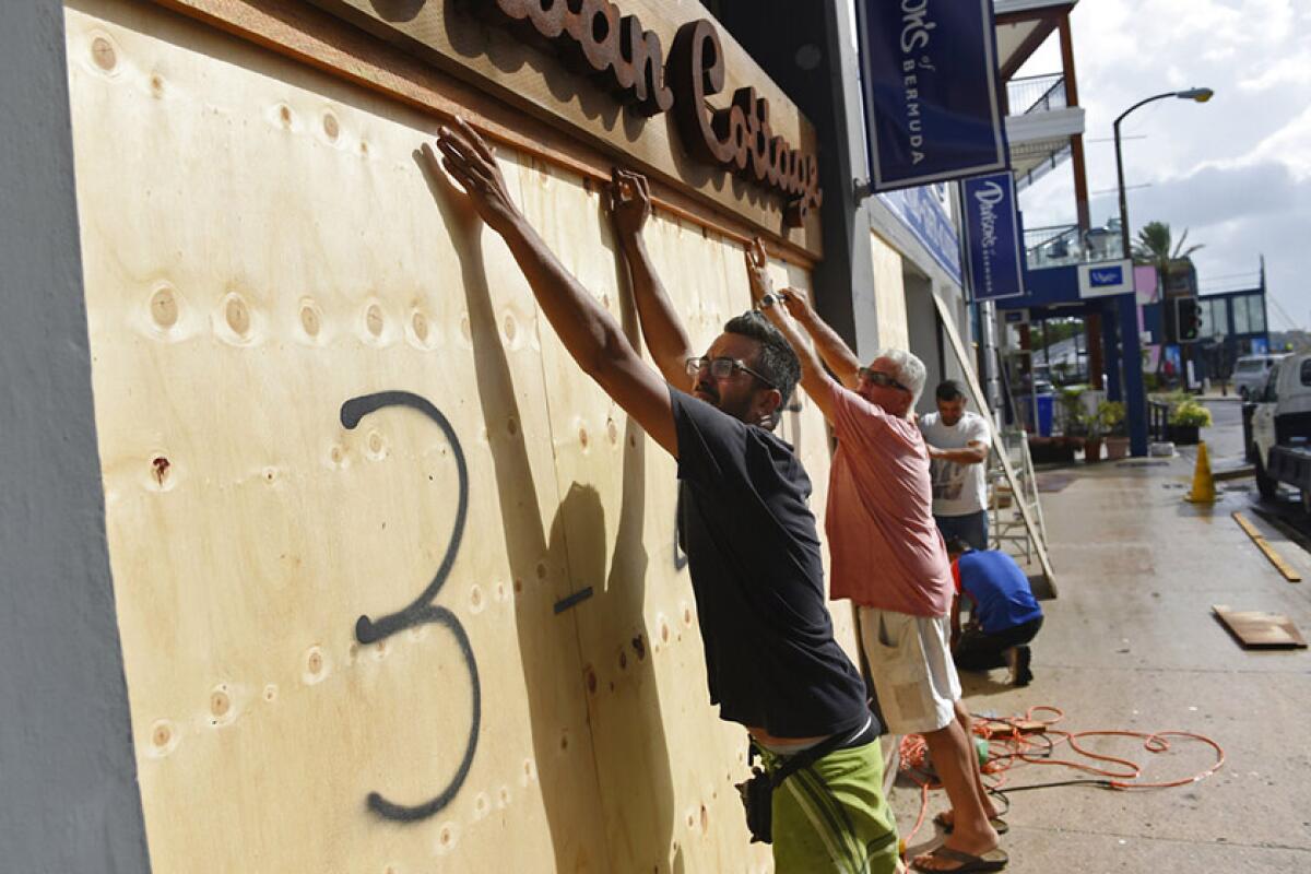 A store in Hamilton, Bermuda, is boarded up Sept. 18 in preparation for Hurricane Humberto.
