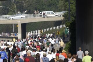 2003 photo of walkers take their turn hiking an eight-mile section of the 110 Pasadena Freeway during Sunday's Arroyo Fest. 