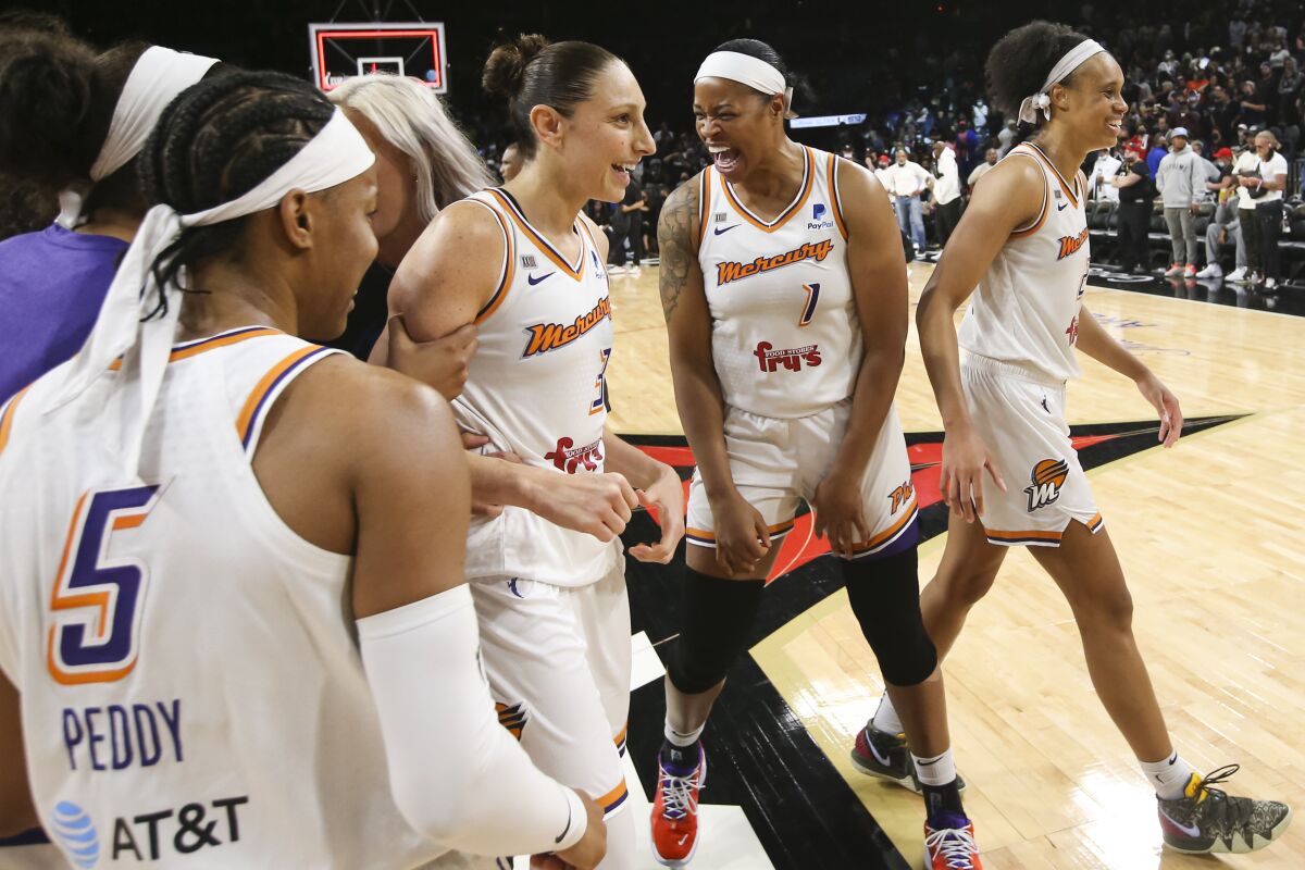 Phoenix Mercury guard Diana Taurasi (3) celebrates with teammates after they defeated the Las Vegas Aces 87-84 in Game 5 of a WNBA basketball playoff series Friday, Oct. 8, 2021, in Las Vegas. (AP Photo/Chase Stevens)