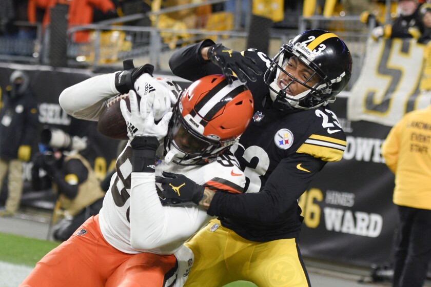 Cleveland Browns tight end David Njoku (85) makes a touchdown catch as Pittsburgh Steelers cornerback Joe Haden (23) defends during the second half an NFL football game, Monday, Jan. 3, 2022, in Pittsburgh. (AP Photo/Don Wright)