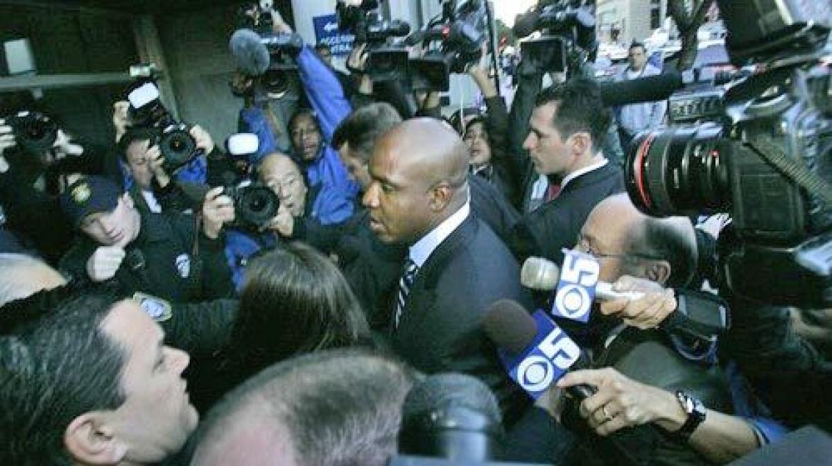 Barry Bonds is met by the media at the Federal Building in San Francisco.