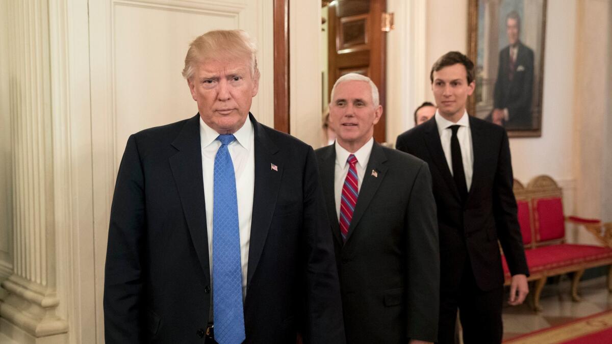 Donald Trump, Vice President Mike Pence, and Senior Advisor to President Trump Jared Kushner enter the State Dining Room, in front of an oil portrait of former U.S. President Ronald Reagan.