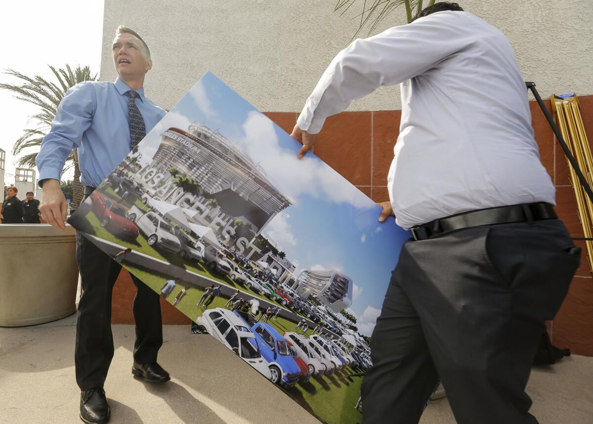 A rendering for a proposed NFL stadium by the owners of the San Diego Chargers and Oakland Raiders is packed after a news conference last week in Carson, where the facility has been proposed.