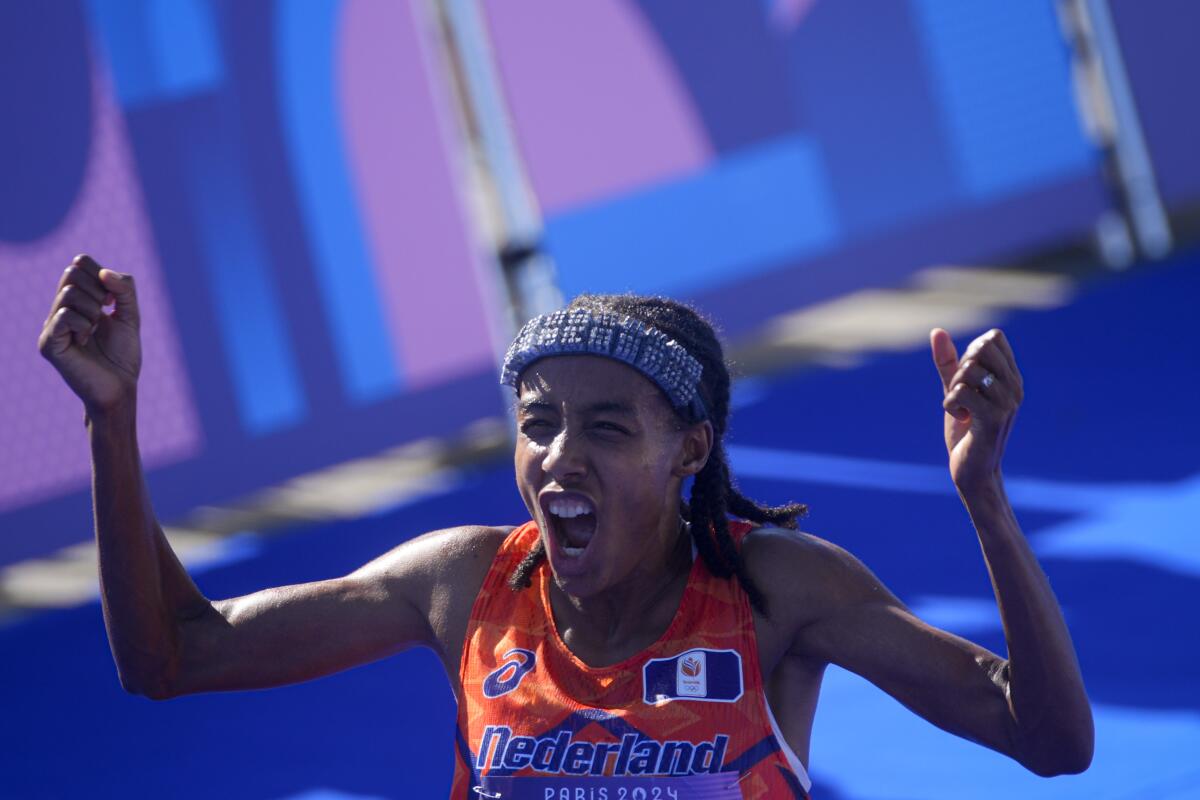 Sifan Hassan of the Netherlands celebrates after crossing the finish line to win gold.