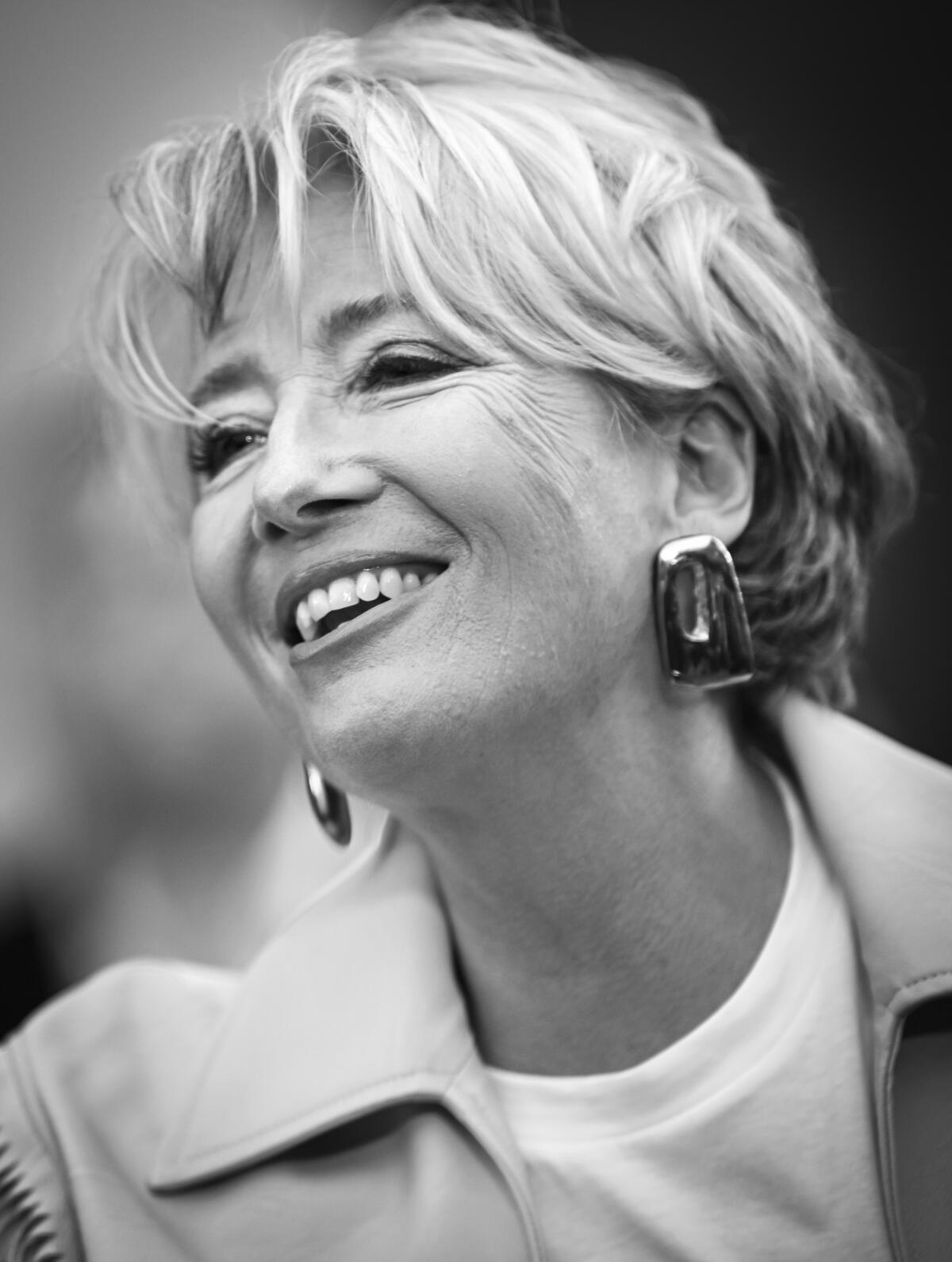 A black and white portrait of actor Emma Thompson.