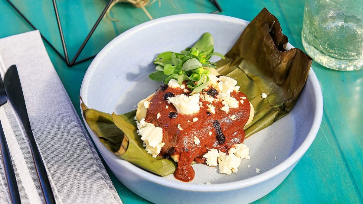 The tamal con mole poblano at El Jardín is one of many tribute dishes, elevated renditions of regional cuisine that's been cooked for generations.