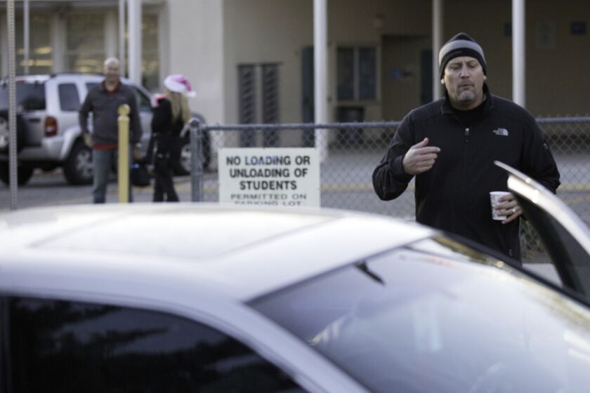 Hale Charter Academy principal Chris Perdigao instructs parents trying to drop kids off at the Woodland Hills campus on Dec. 15 that the school is closed.