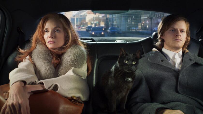 Michelle Pfeiffer, Lucas Hedges and a cat share a car seat in the movie "French Exit."