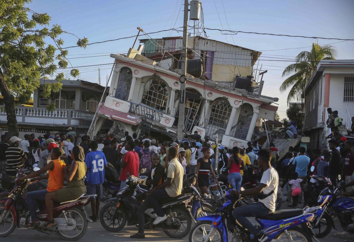 People outside hotel destroyed by Haiti earthquake