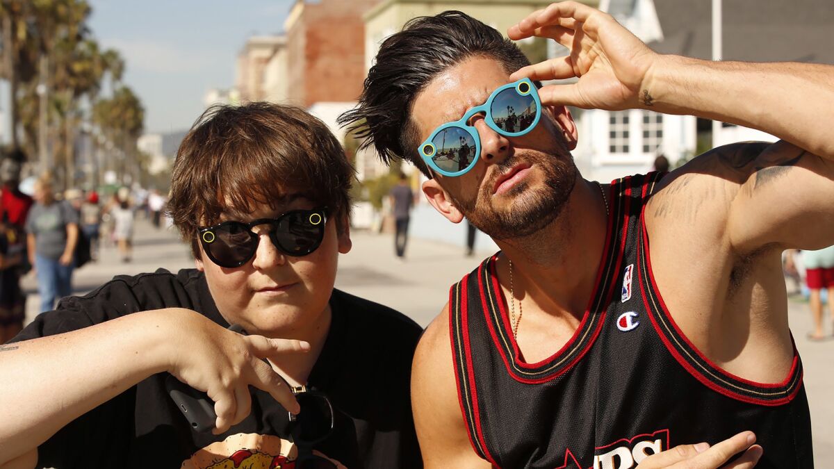 Actor-comedian Andy Milonakis, 40, left, and YouTube star Jesse Wellens, 34, try on their Snapchat Spectacles in Venice.