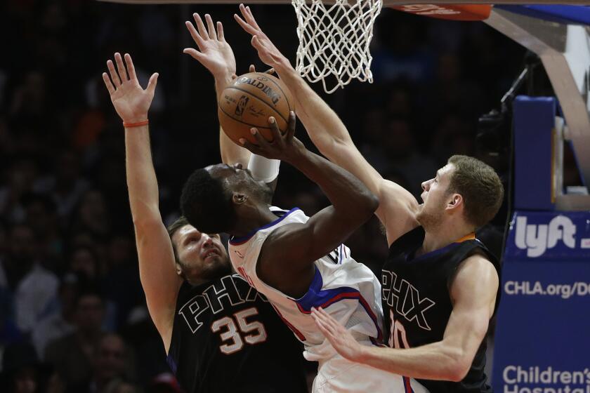 Clippers forward Jeff Green is fouled as he tries to shoot over Phoenix Suns forward Jon Leuer, right, and Mirza Teletovic during a Feb. 22 game at Staples Center.