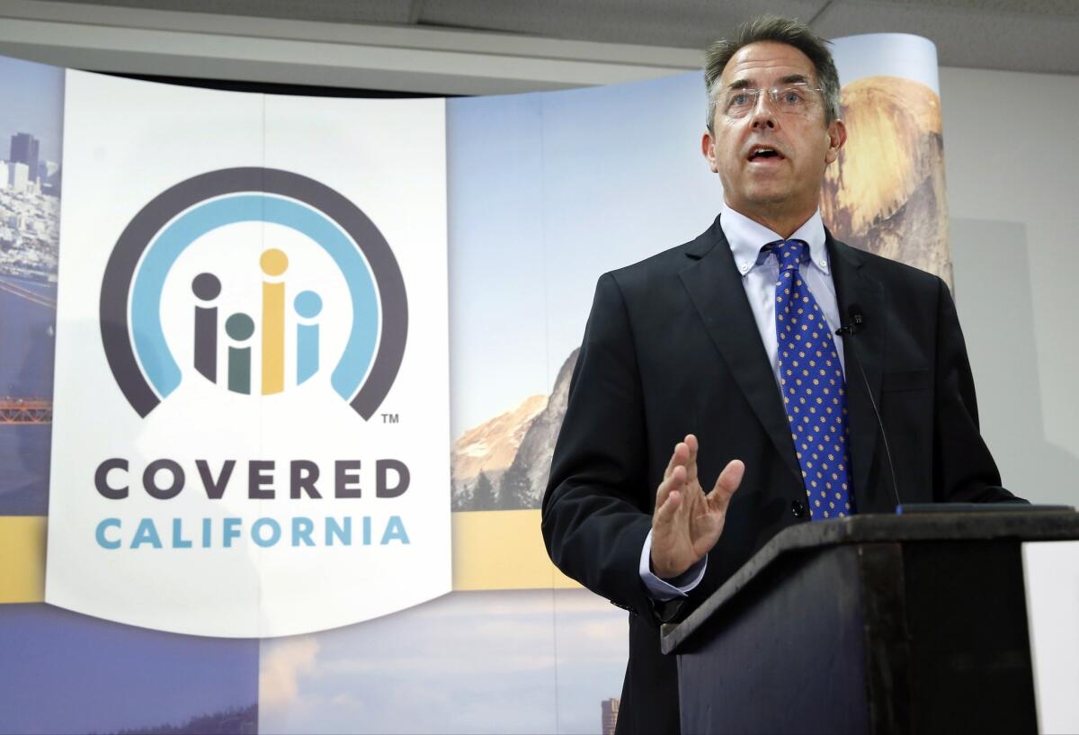 The Covered California exchange might have enrolled more people Monday, but some applicants experienced delays, said Peter Lee, executive director of Covered California. Above, Lee speaks during a news conference last month in Sacramento.