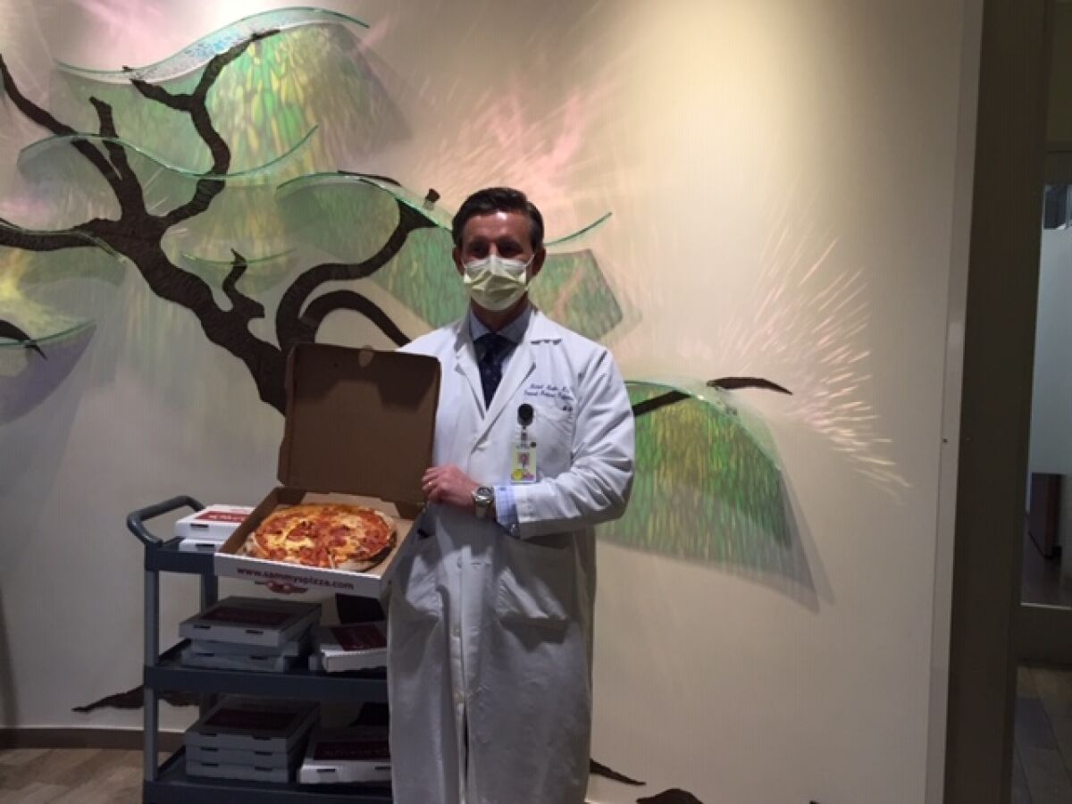 Dr. Michael Martin, internal medicine at Sharp Rees-Stealy Medical Group, is ready to dig into his pizza.