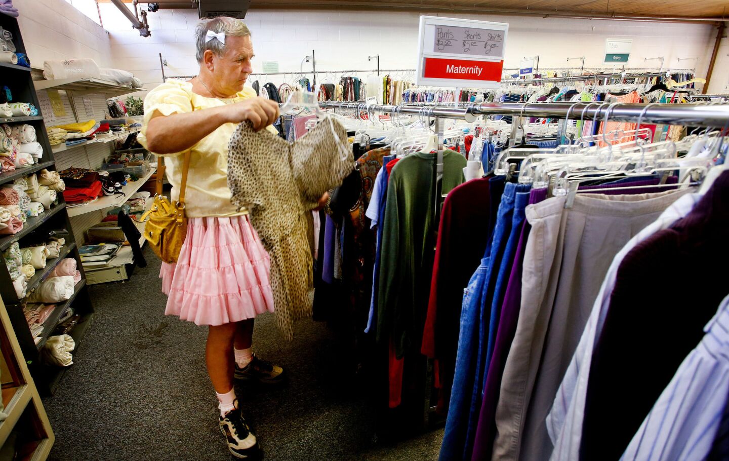 Goodwin shops for an outfit at secondhand store in Casper. He began secretly dressing in girls clothes in his youth as "an escape from a hostile environment."