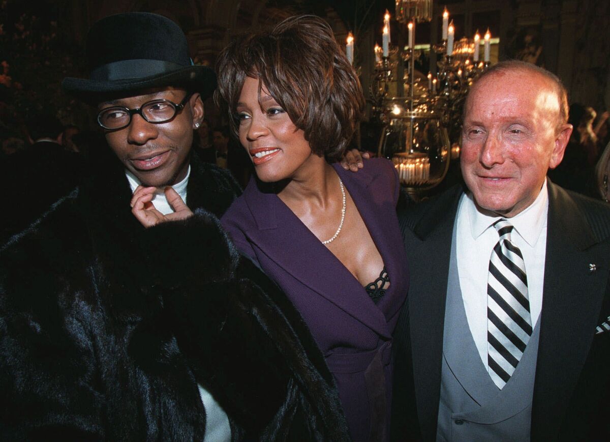 Bobby Brown, from left, Whitney Houston and Clive Davis in 1998.
