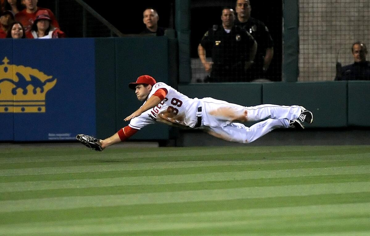 Angels' J.B. Schuck makes a diving catch in the fourth inning against the Kansas City Royals.