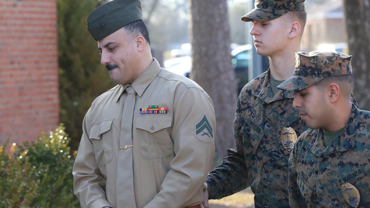 Cpl. Wassef Hassoun is escorted to the courtroom at Camp Lejeune in Jacksonville, N.C., on Feb. 9 for the beginning of his court-martial trial.