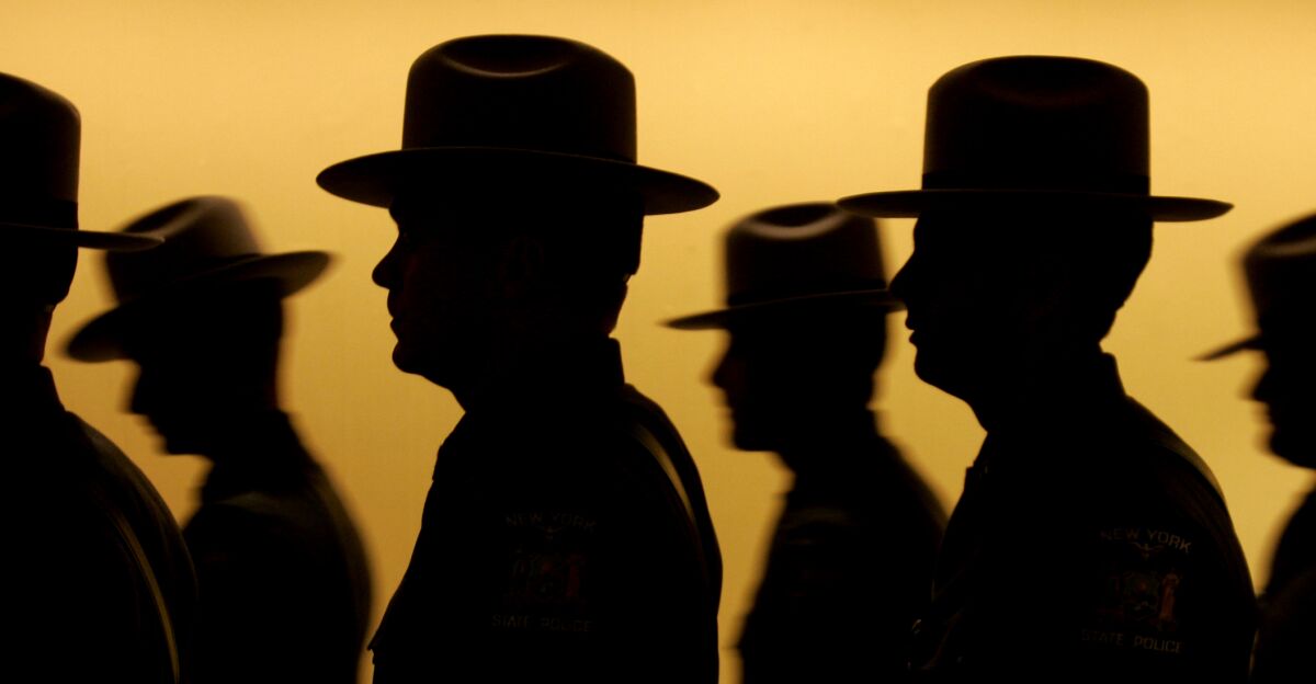 FILE - This Oct. 21, 2008, file photo, shows a silhouette of some of the 92 graduating New York State Police officers as they line up before a ceremony at the Empire State Plaza Convention Center in Albany, N.Y. The New York State Police agency remains overwhelmingly white, an imbalance some troopers say is rooted in a legacy of racism. (AP Photo/Mike Groll, File)