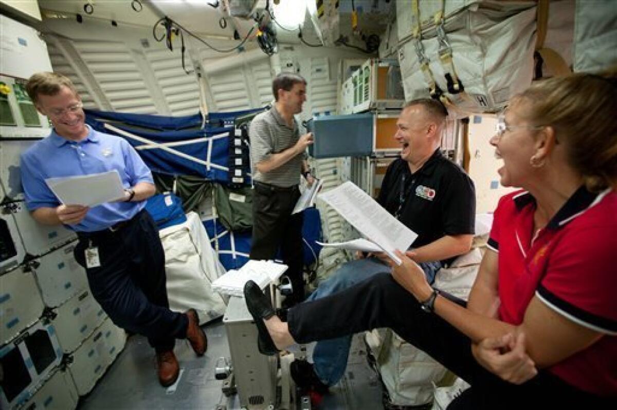 In this Wednesday, June 29, 2011 photo, the crew of STS-135, from left, Chris Ferguson, Rex Walheim, Doug Hurley and Sandy Magnus review procedures on the mid-deck of the Crew Compartment Trainer (CCT) II mockup as they train at the Johnson Space Center, in Houston. The training marked the crew's final scheduled session in JSC Building 9, before space shuttle Atlantis' scheduled liftoff on July 8. (AP Photo/Houston Chronicle, Smiley N. Pool) MANDATORY CREDIT