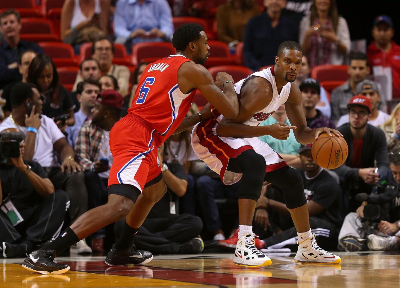 Miami center Chris Bosh backs down DeAndre Jordan during the first half of a game on Nov. 20.