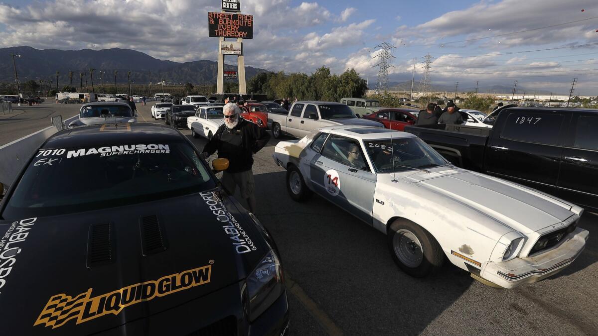 Drivers line up to race at Irwindale Speedway.