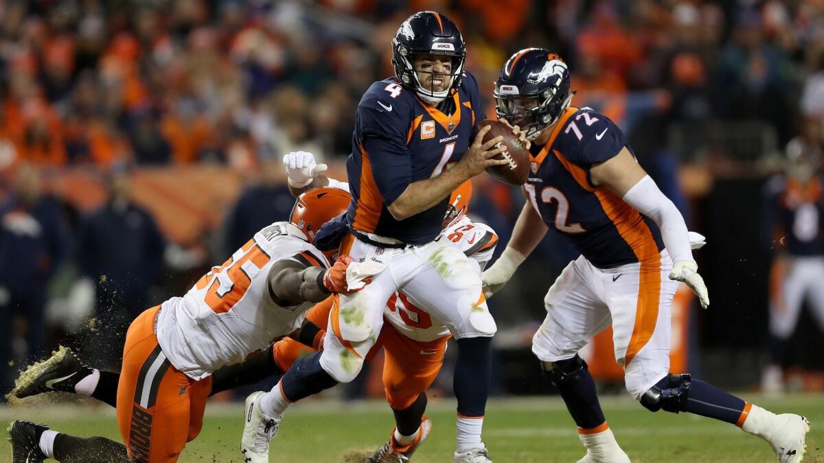 Denver Broncos quarterback Case Keenum attempts to break free from the Cleveland Browns' Genard Avery during a game on Dec. 15 in Denver.