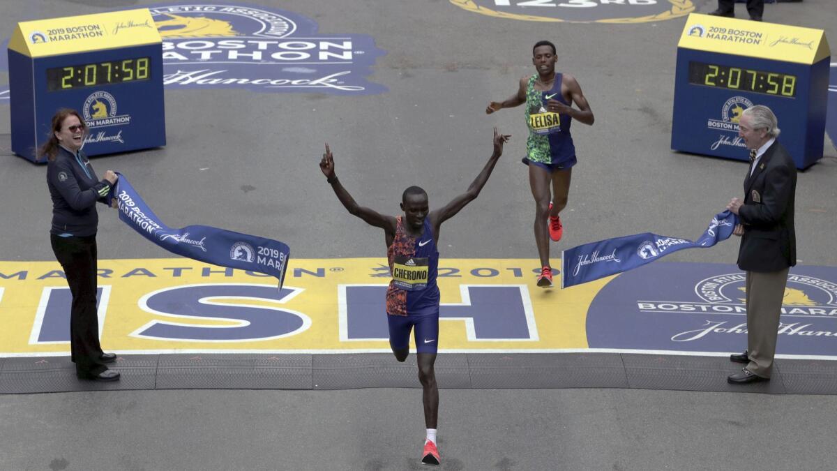 Kenya's Lawrence Cherono breaks the tape to win the 123rd Boston Marathon in front of Ethiopia's Lelisa Desisa on April 15.