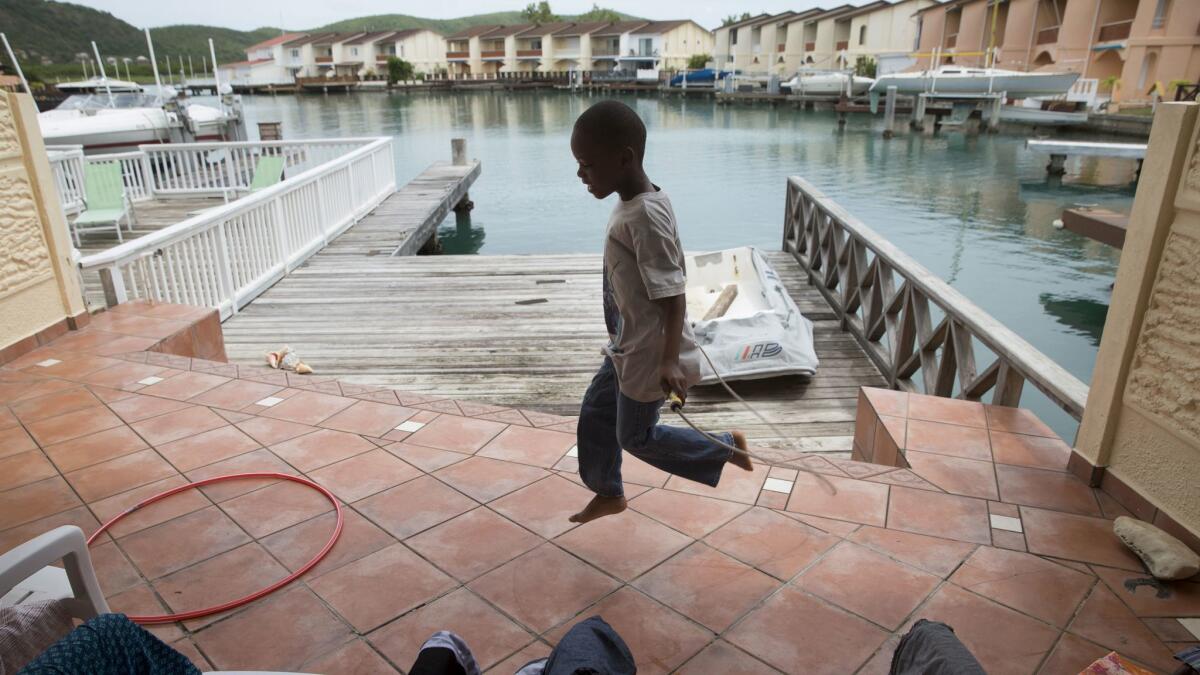 Kedar Cephas, 8, plays outside his temporary home in St. John's, the Antiguan capital.