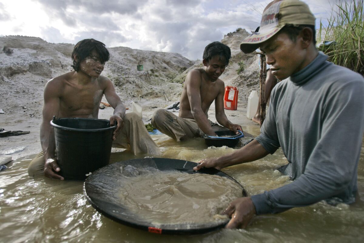 Traditional miners pan for gold at a mine in Hampalit, Indonesia. Soaring prices for the precious metal have given rise to a doubling of toxic mercury emissions over the last eight years from unregulated gold processing at tens of thousands of remote sites, mostly in Asia, Latin America and Africa.