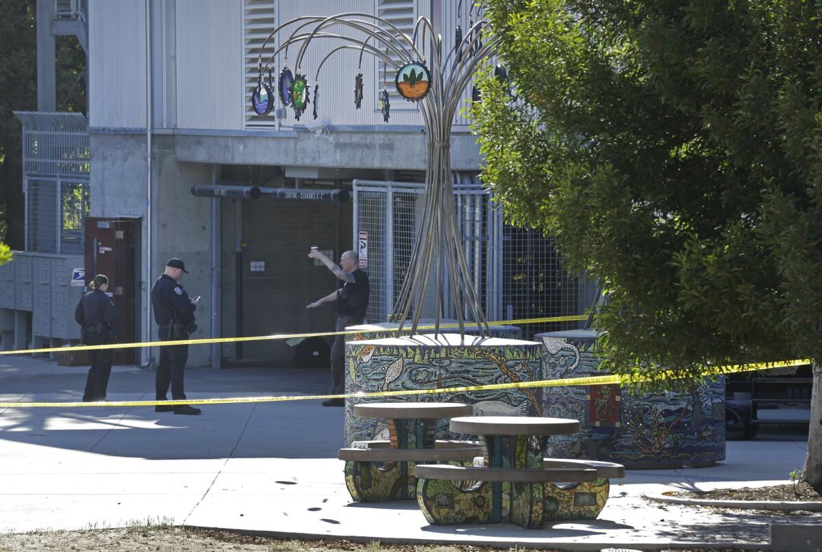 San Jose police guard the entrance to the garage on Tuesday, July 28, 2015, after police found a body inside a trash bin on Monday in Santa Cruz.