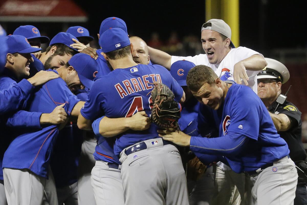 Dylan Cressy, top right, celebrates the no-hitter of Cubs starting pitcher Jake Arrieta (49) after running onto the field.