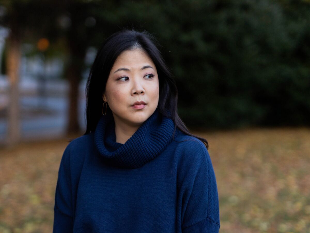 A photo of a woman dressed in blue and standing outside.