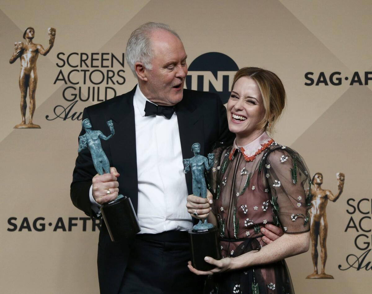 John Lithgow holds his award for Outstanding Performance by a Male Actor in a Drama Series for his role in "The Crown" as he embraces Claire Foy, who holds the award she won for Outstanding Performance by a Female Actor in a Drama Series for her role also in "The Crown" backstage at the 23rd Screen Actors Guild Awards in Los Angeles, California, U.S., January 29, 2017. REUTERS/Mario Anzuoni ** Usable by SD ONLY **