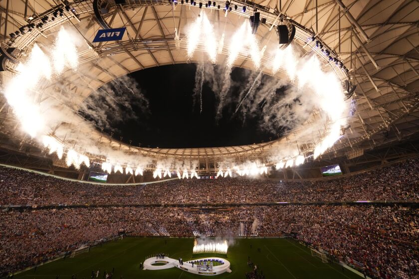 Fireworks explode as Argentina's team receives the trophy at the end of the World Cup final soccer match between Argentina and France at the Lusail Stadium in Lusail, Qatar, Sunday, Dec. 18, 2022. Argentina won 4-2 in a penalty shootout after the match ended tied 3-3. (AP Photo/Hassan Ammar)