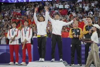 Medalists, from left to right, China's Liang Weikeng and Wang Chang, silver, Taiwan's Lee Yang and Wang Chi-Lin, gold, and Malaysia's Aaron Chia and Soh Wooi Yik, bronze, stand on the podium during the medal ceremony for the men's doubles badminton at the 2024 Summer Olympics, Sunday, Aug. 4, 2024, in Paris, France. (AP Photo/Dita Alangkara)