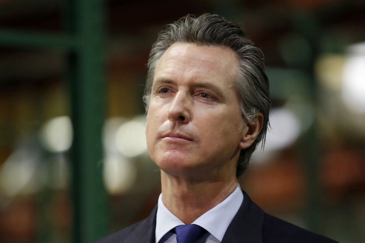 Gov. Gavin Newsom listens during a news conference in Rancho Cordova, Calif.