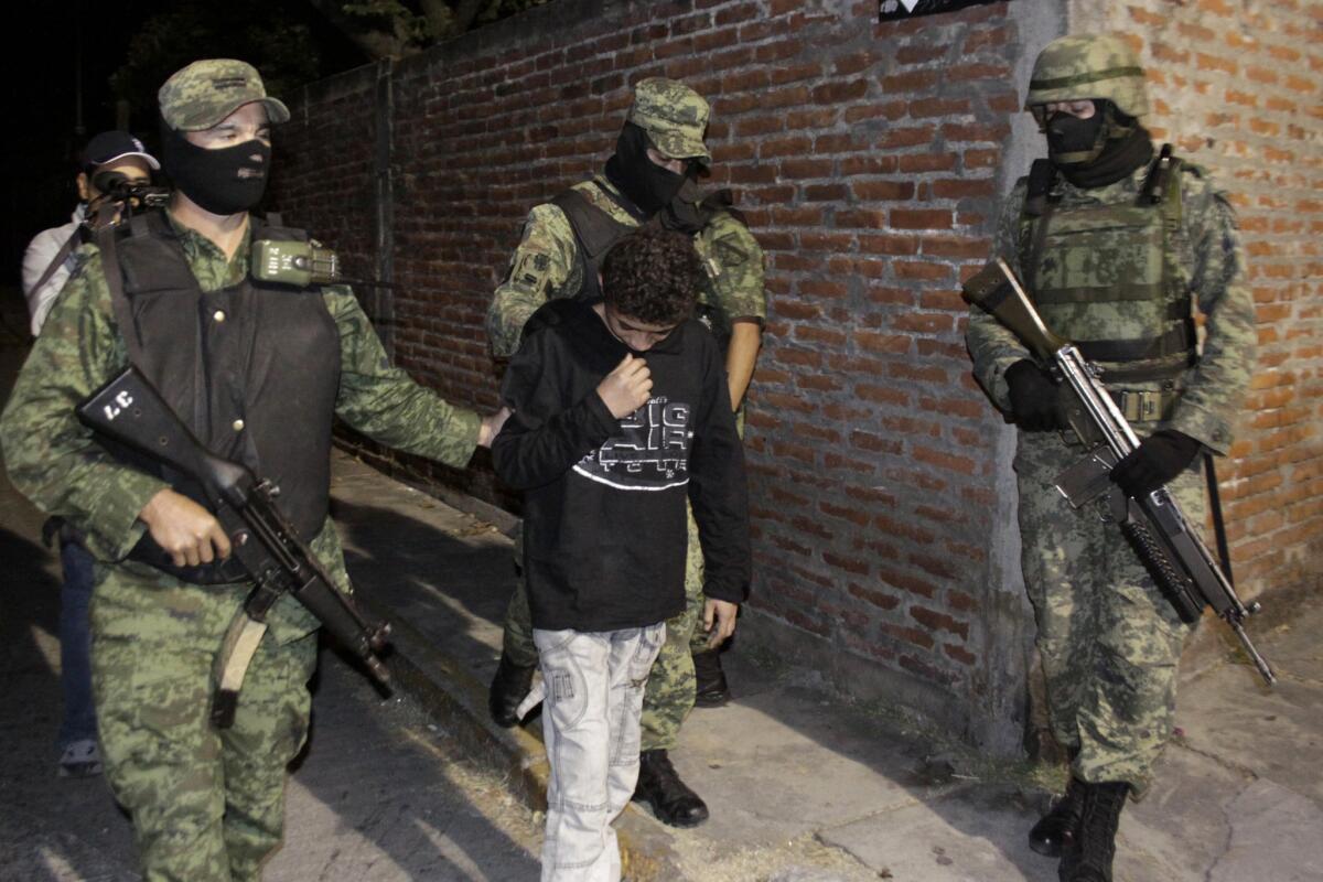 Mexican soldiers present Edgar Jimenez Lugo, known as "El Ponchis," to the media in the city of Cuernavaca in 2010.